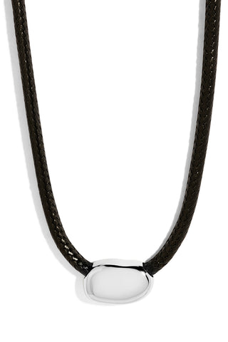 Necklace with black cord and sterling silver sculptural pendant on a white background