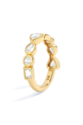 Gold ring with bezel set white sapphires on a white background