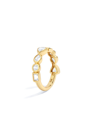 Gold tennis ring with bezel set lab grown white sapphires alternating in stone shape on a white background
