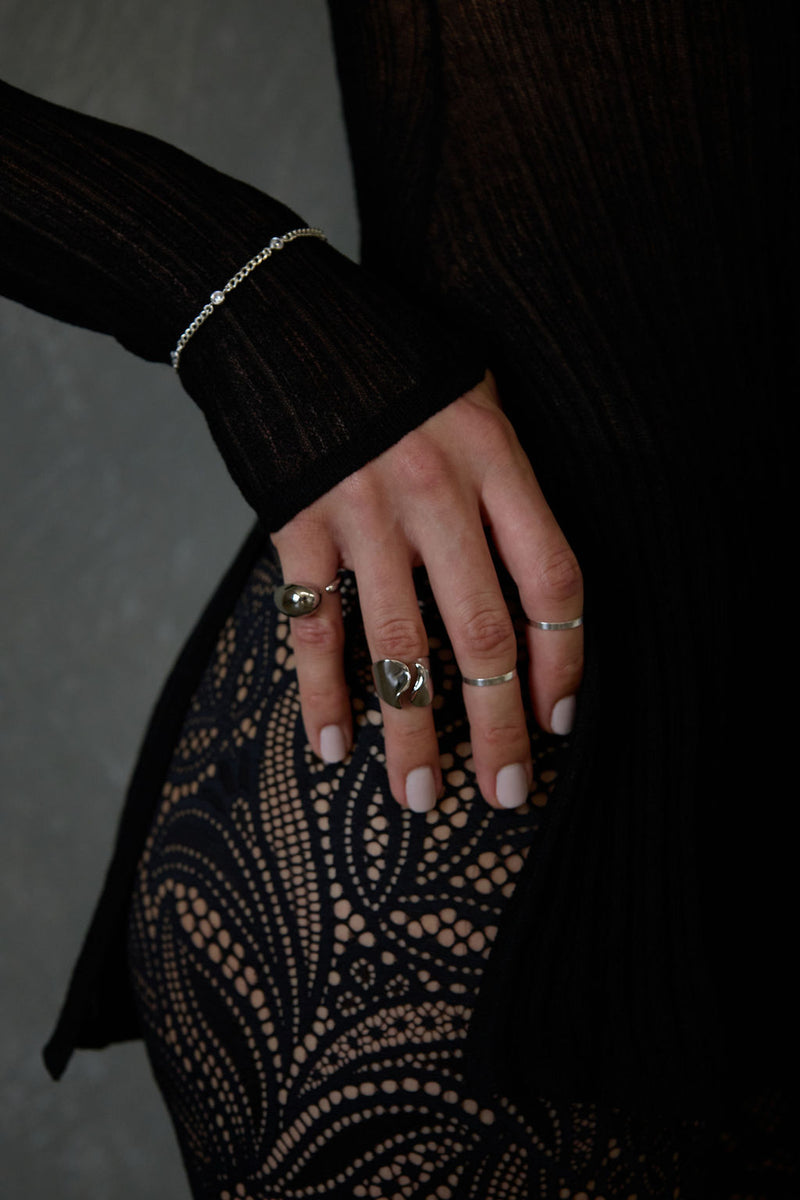 NAiiA Violet Bracelet and silver rings on model