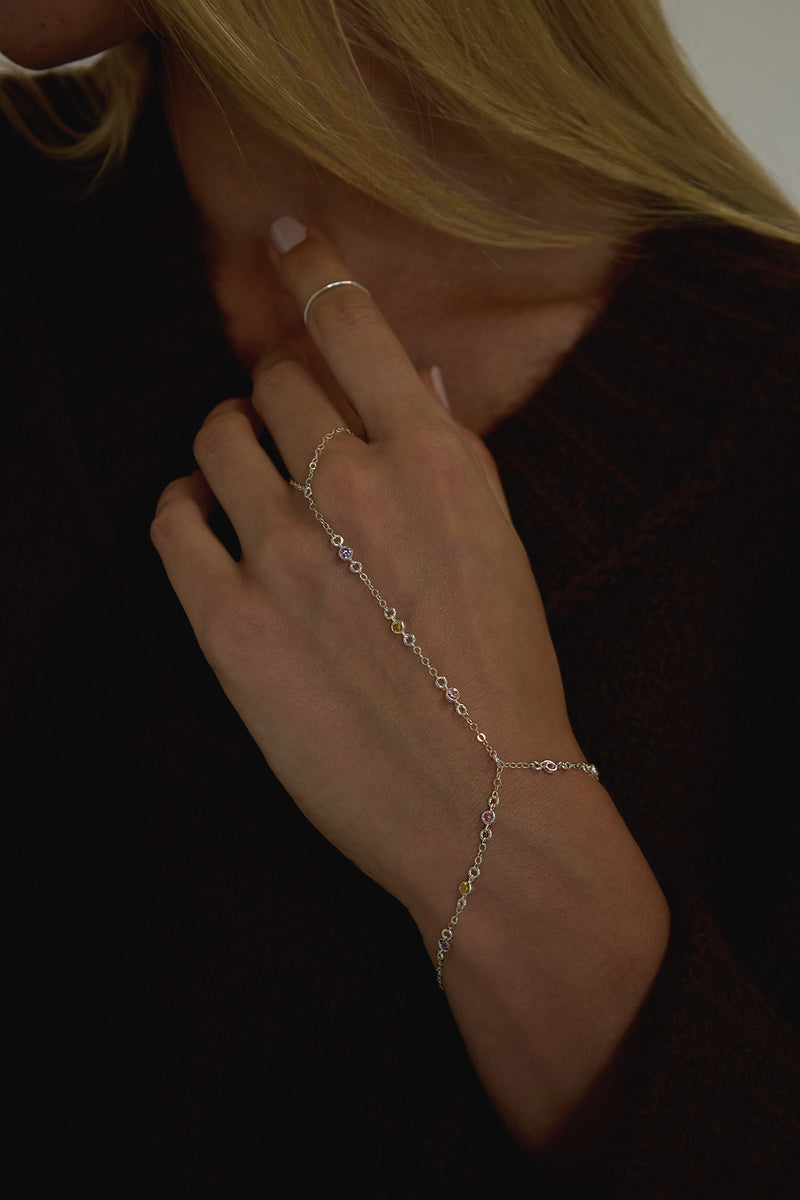 naiia tessa hand chain and coco ring in silver on model