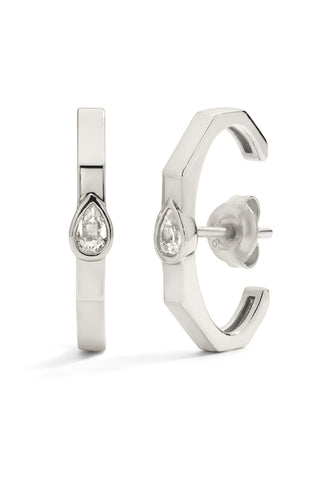 Silver hoop earrings with pear-shaped gemstones on a white background
