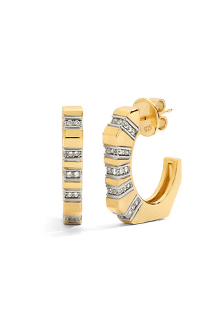 Gold angular hoop earrings with lines of  pave-set lab grown white sapphire accents on a white background