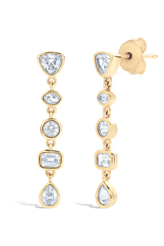 Gold earrings with bezel set white sapphires on a white background