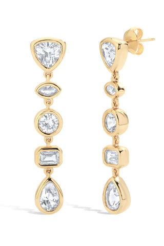 Gold earrings with bezel set white sapphires on a white background
