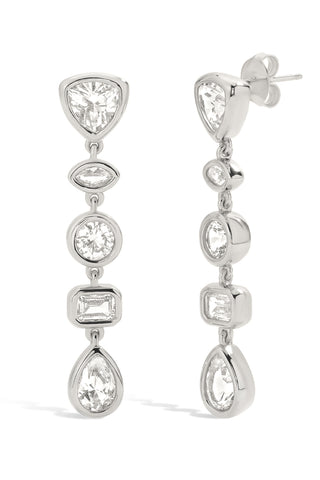 Sterling silver earrings with bezel set white sapphires on a white background