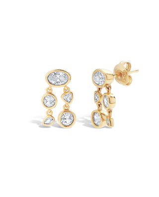 Pair of gold clustered bezel set earrings featuring a bezel drop with lab grown white sapphires on a white background