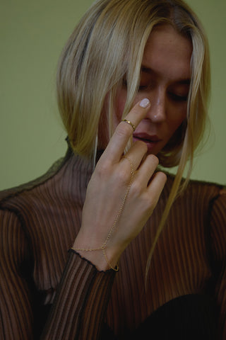 gold hand chain, blonde model