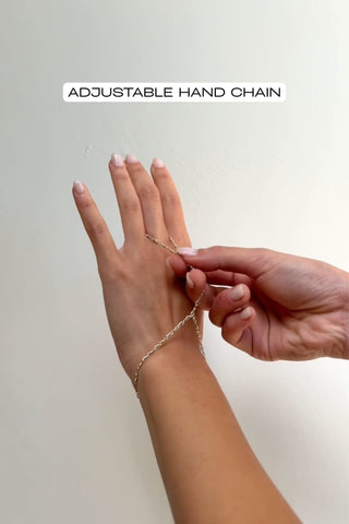 video of mixed metal hand chain being adjusted to fit a finger