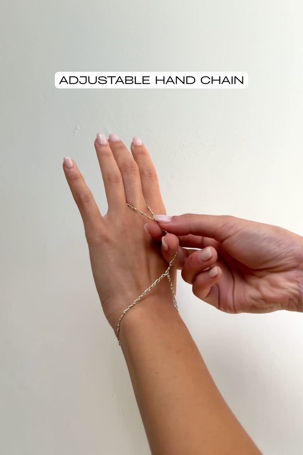 video of mixed metal hand chain being adjusted to fit a finger