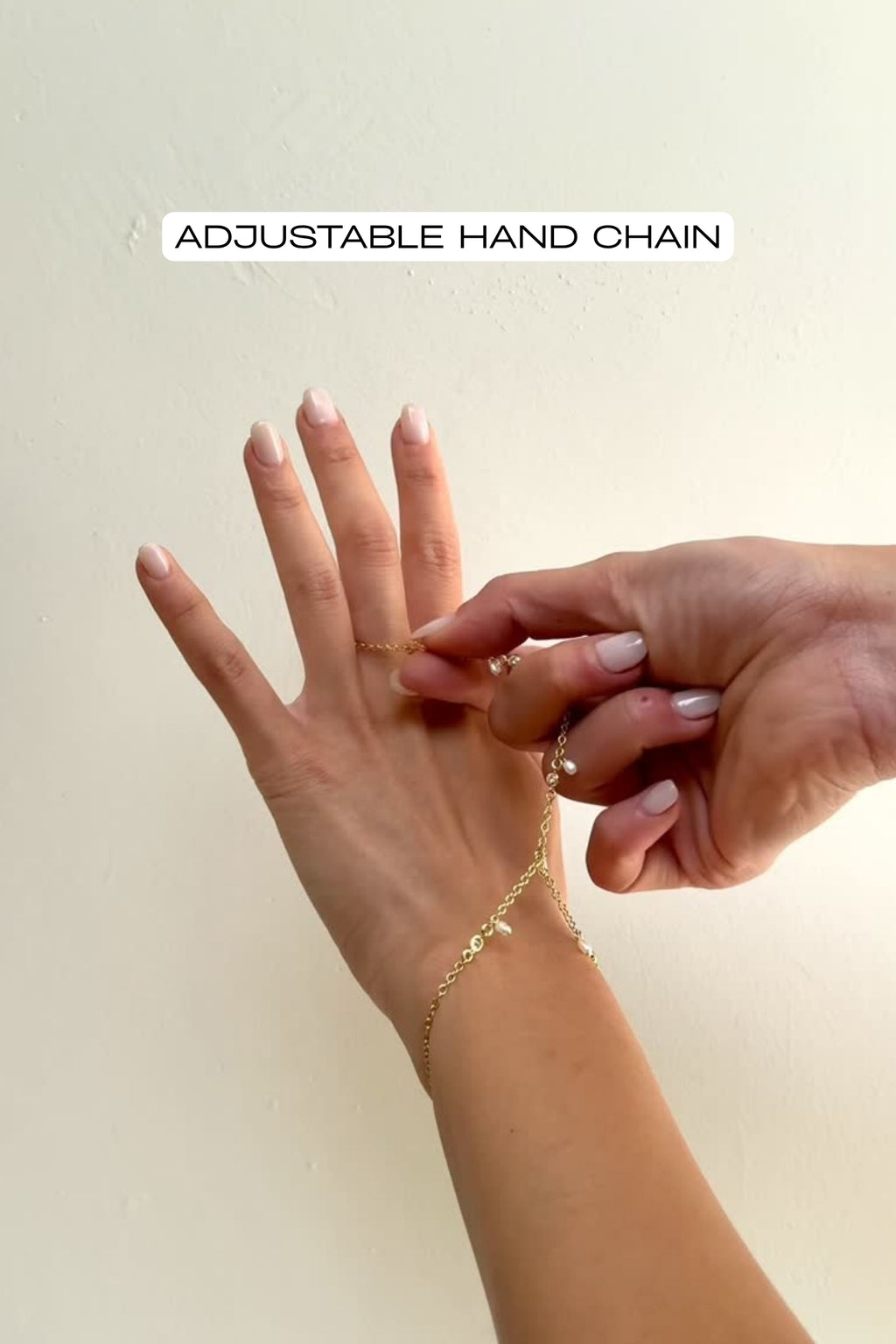 video of Noa pearl and CZ hand chain adjusted to fit finger