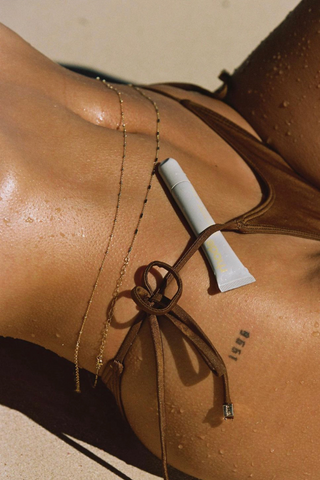 Hailey Bieber for her Rhode campaign in NAiiA Sierra belly chain